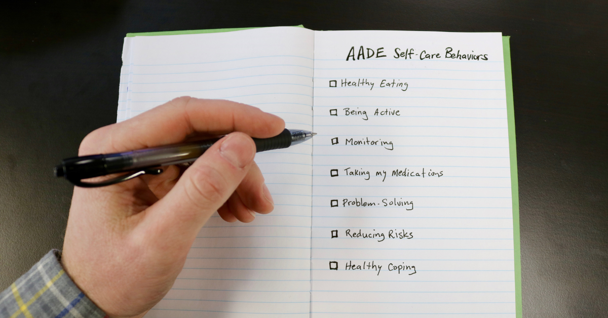 Writing in a notebook: AADE Self-care Behaviors