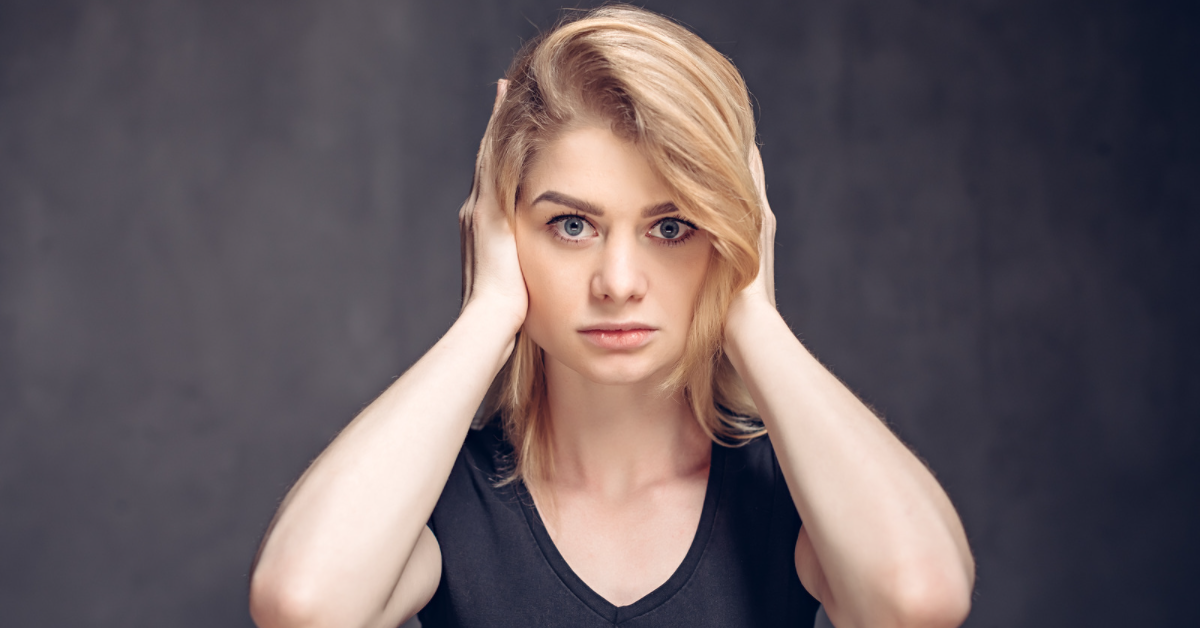 Woman covering her ears