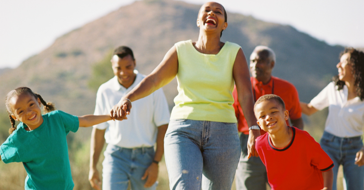 Family smiling while on a walk