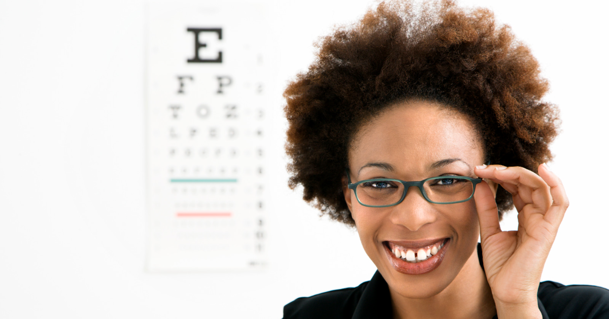 Woman smiling and posing at an eye doctor appointment