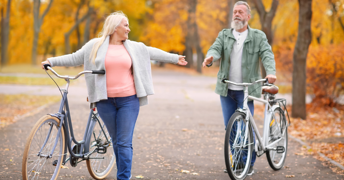 Two people walking with bicycles