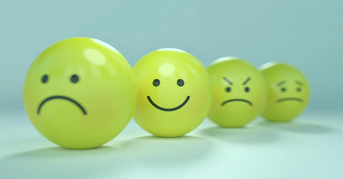 Ping pong balls with different emotional faces drawn on each.