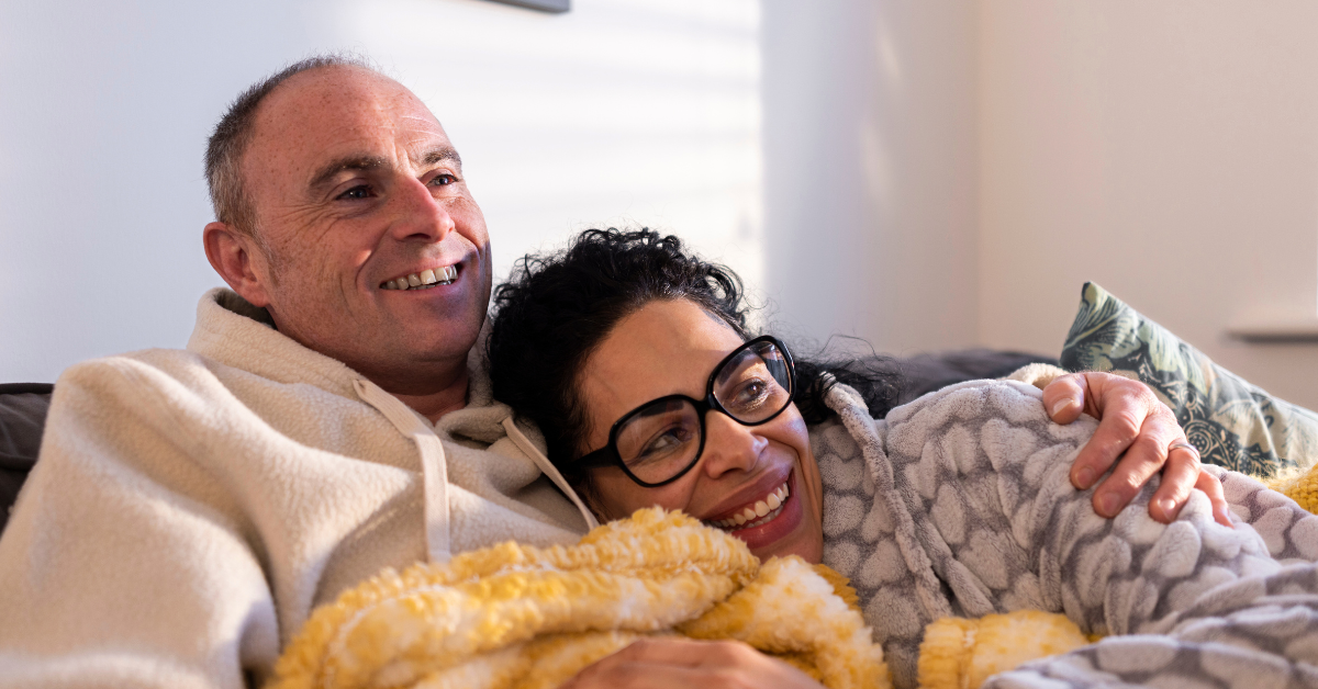 A couple snuggling on a couch