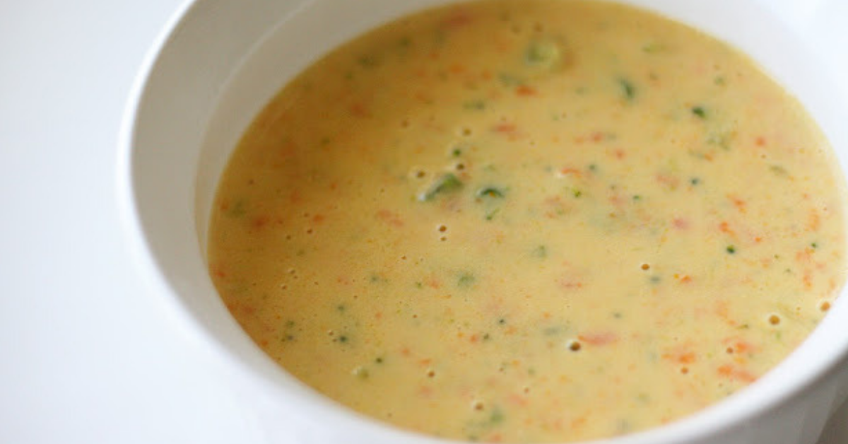 Cheesy broccoli soup in a white bowl