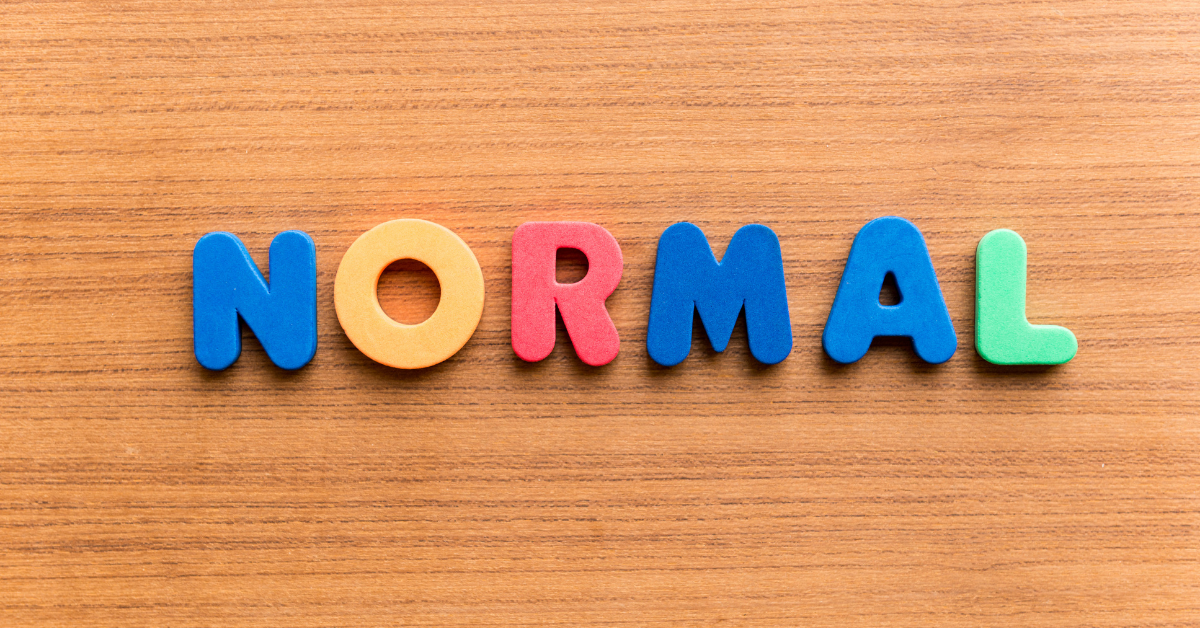 Letters on a wood surface: NORMAL