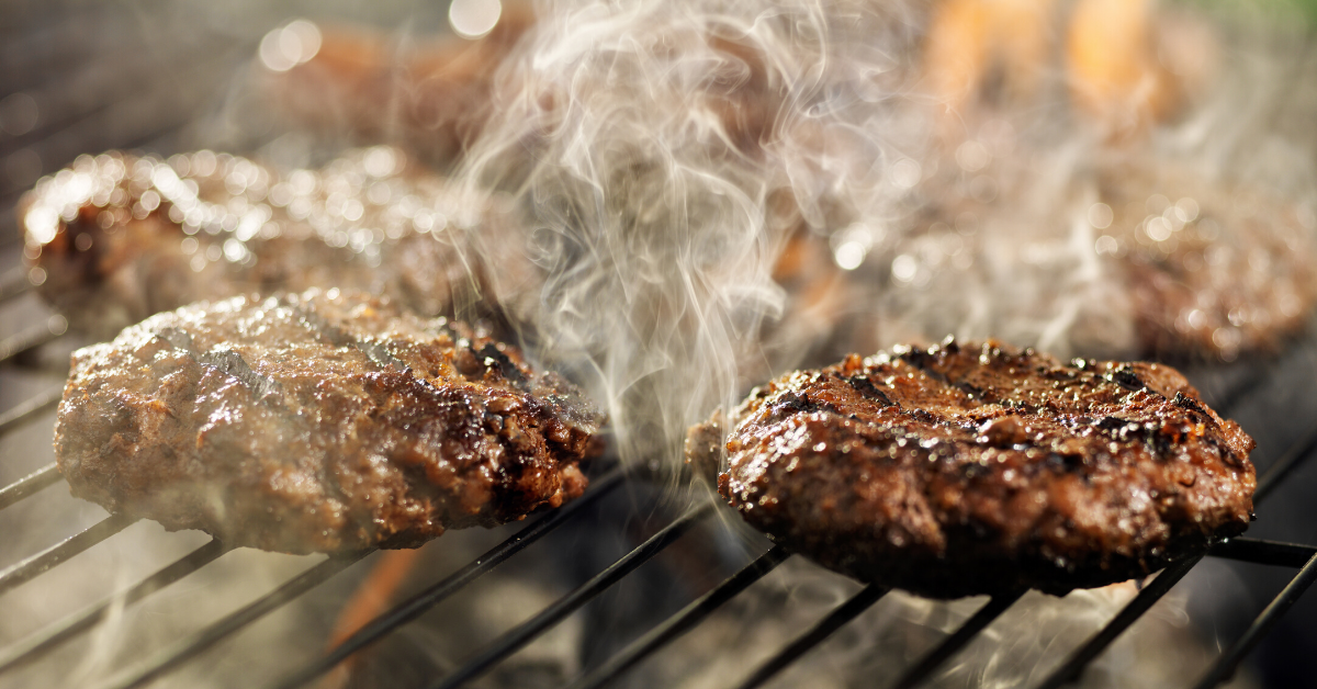 Hamburgers cooking on a grill