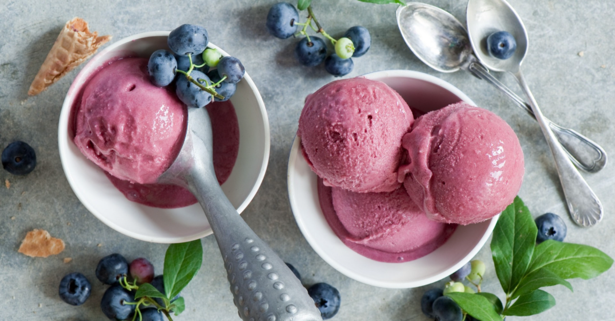 Scoops of ice cream with blueberries all around