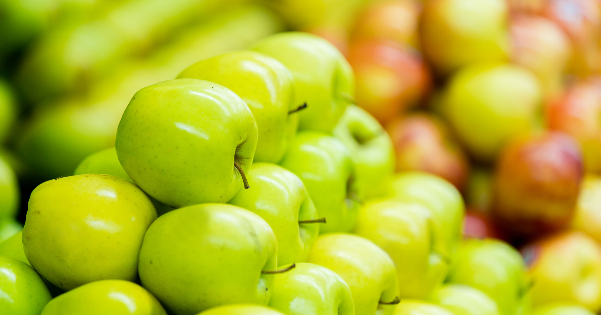 Green and red apples stacked