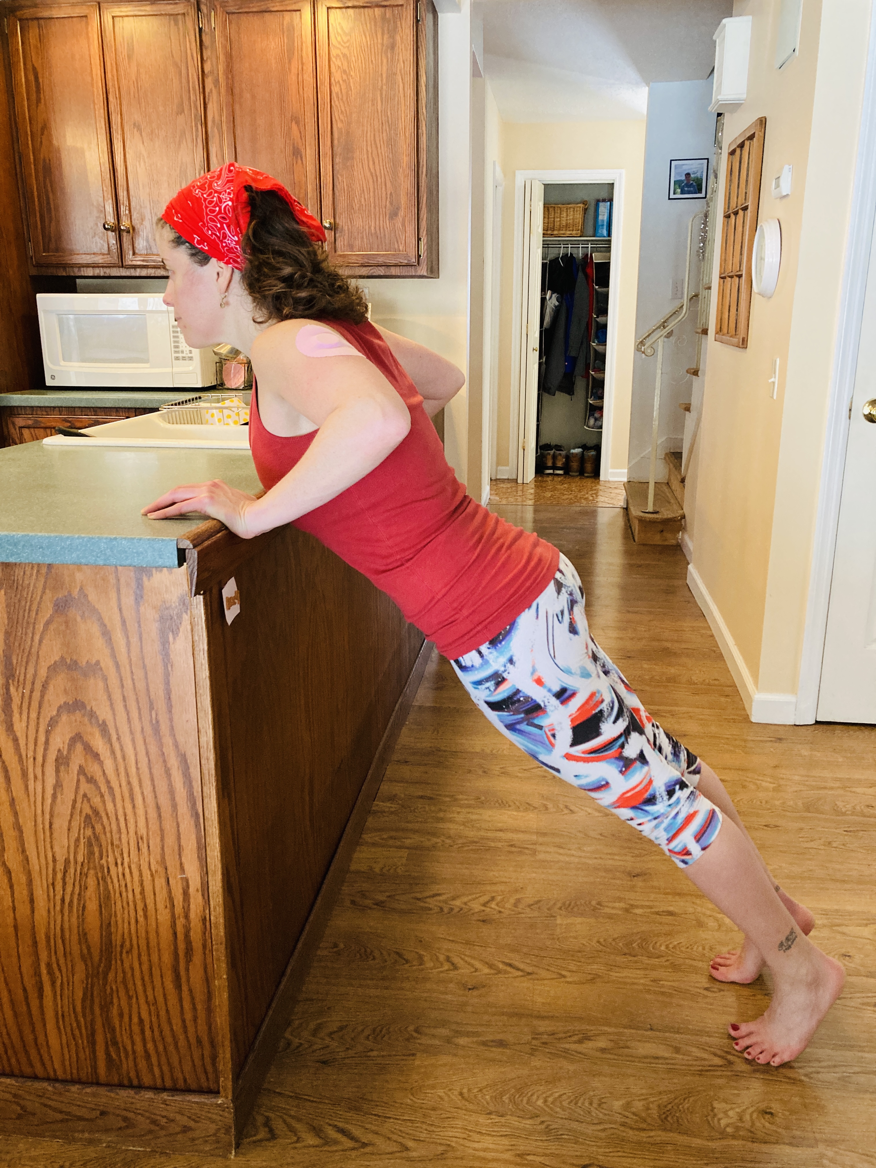 Engage your core to keep your body stiff like a plank as you lower your chest to the counter. At the deepest part of the pushup, your elbows and wrists should be in line with each other.