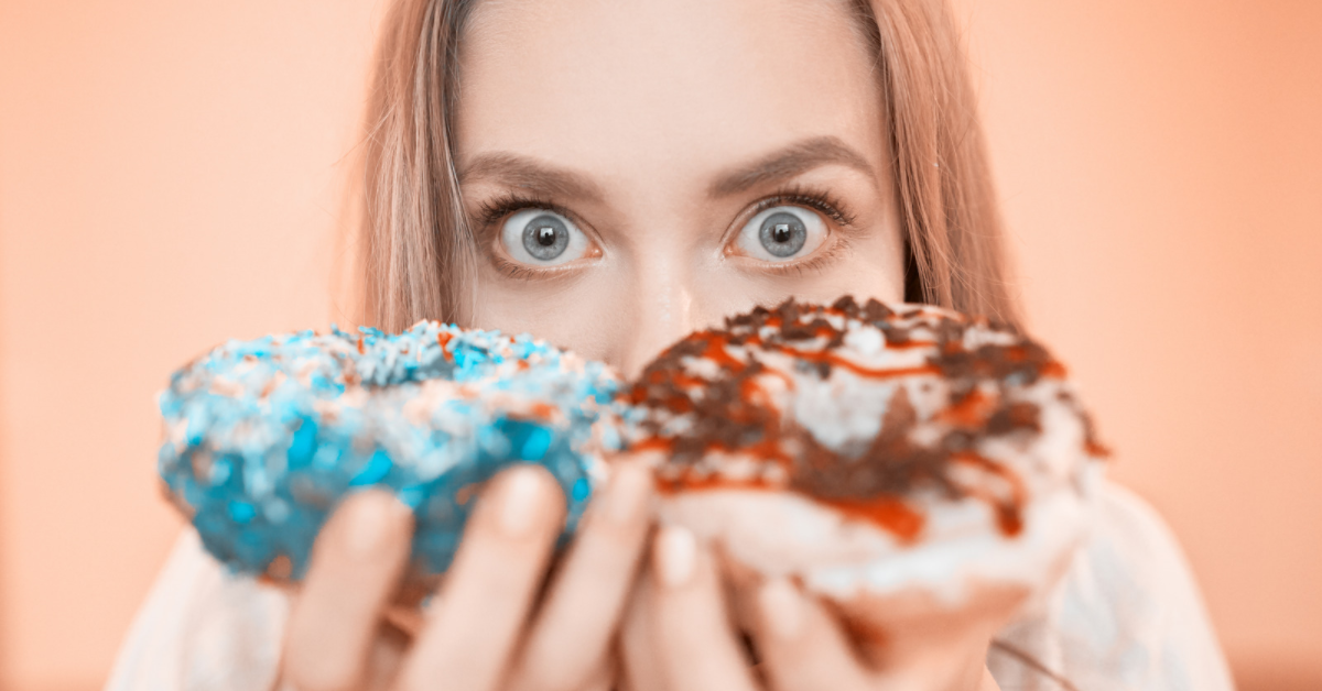 Woman holding two donuts