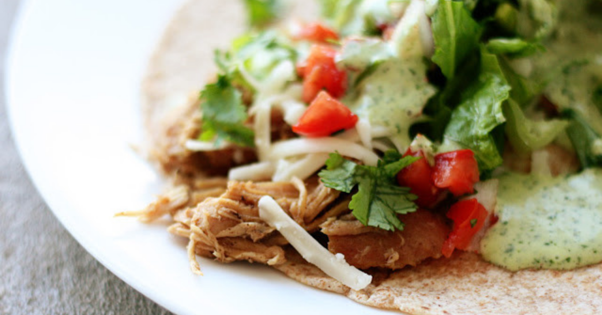 Sweet pork, cheese, veggies, and sauce on a wheat tortilla