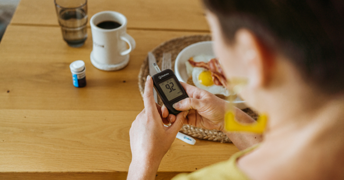 Woman checking her blood sugar before breakfast