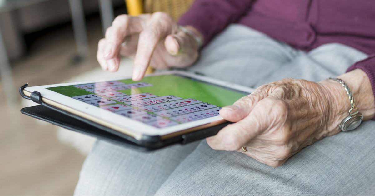 Elderly woman playing a game on an iPad